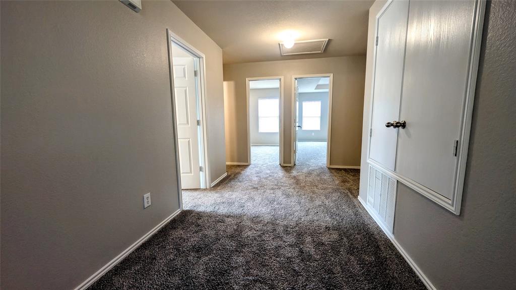 1308 Lamar Lane Allen, TX 75002 - Photo 17 of 40 Hallway featuring carpet flooring, attic access, and a textured wall