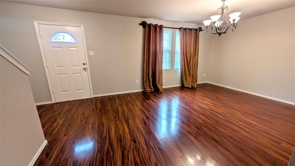 1308 Lamar Lane Allen, TX 75002 - Photo 2 of 40 Entrance foyer with dark wood finished floors, a chandelier, and plenty of natural light