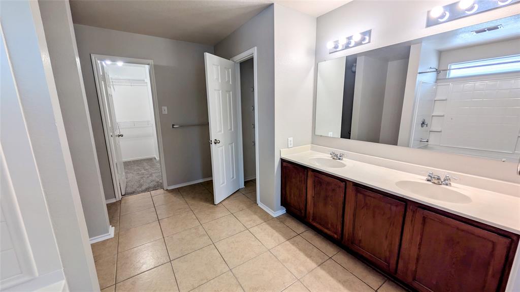 1308 Lamar Lane Allen, TX 75002 - Photo 23 of 40 Full bathroom with double vanity, a shower, tile patterned floors, and a spacious closet