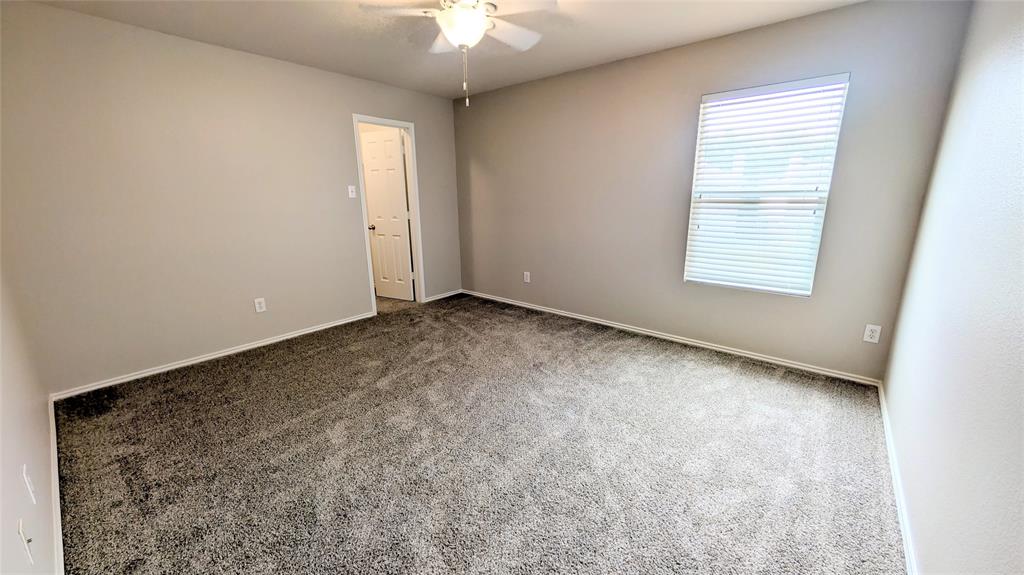 1308 Lamar Lane Allen, TX 75002 - Photo 26 of 40 Empty room with dark carpet and a ceiling fan