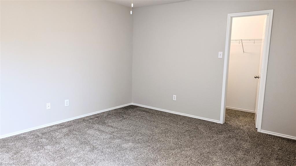 1308 Lamar Lane Allen, TX 75002 - Photo 27 of 40 Unfurnished bedroom featuring a spacious closet and dark colored carpet
