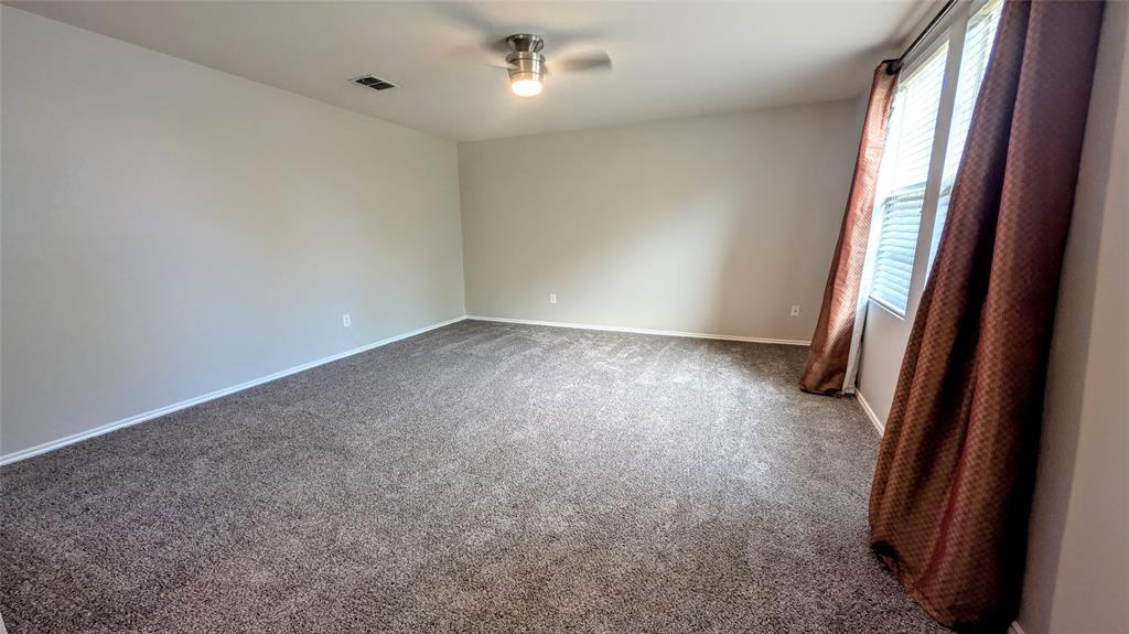 1308 Lamar Lane Allen, TX 75002 - Photo 4 of 40 Empty room featuring carpet floors and a ceiling fan