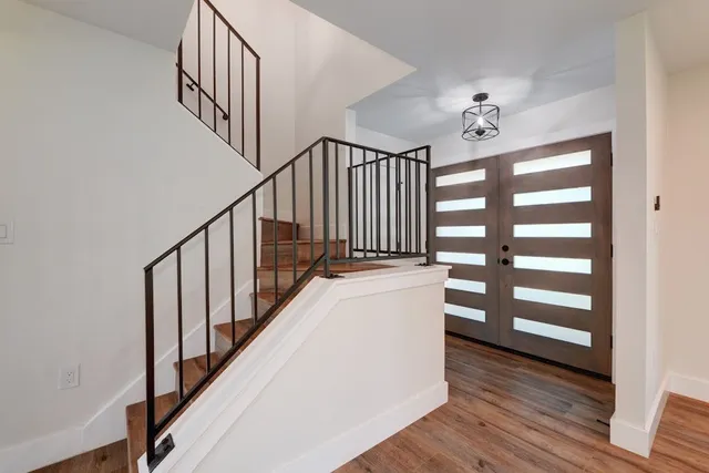 a view of staircase with wooden floor and a window