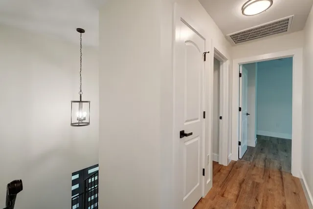 a view of a hallway with wooden floor
