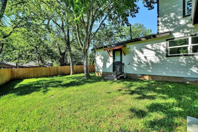 a view of backyard with deck and garden