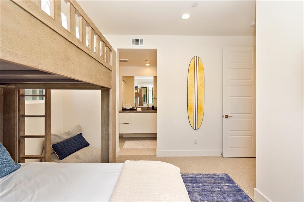 1030 Harbor Boulevard Oxnard, CA 93035 - Photo 20 of 40 a bedroom with a bed a mirror and a window