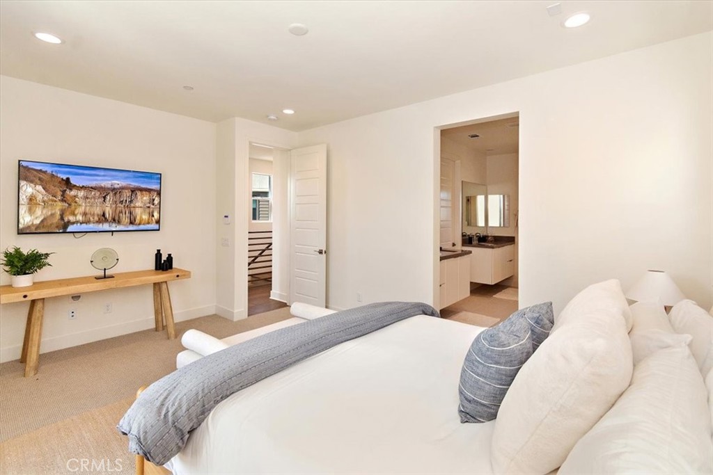 1030 Harbor Boulevard Oxnard, CA 93035 - Photo 25 of 40 a spacious bedroom with a bed and a couch