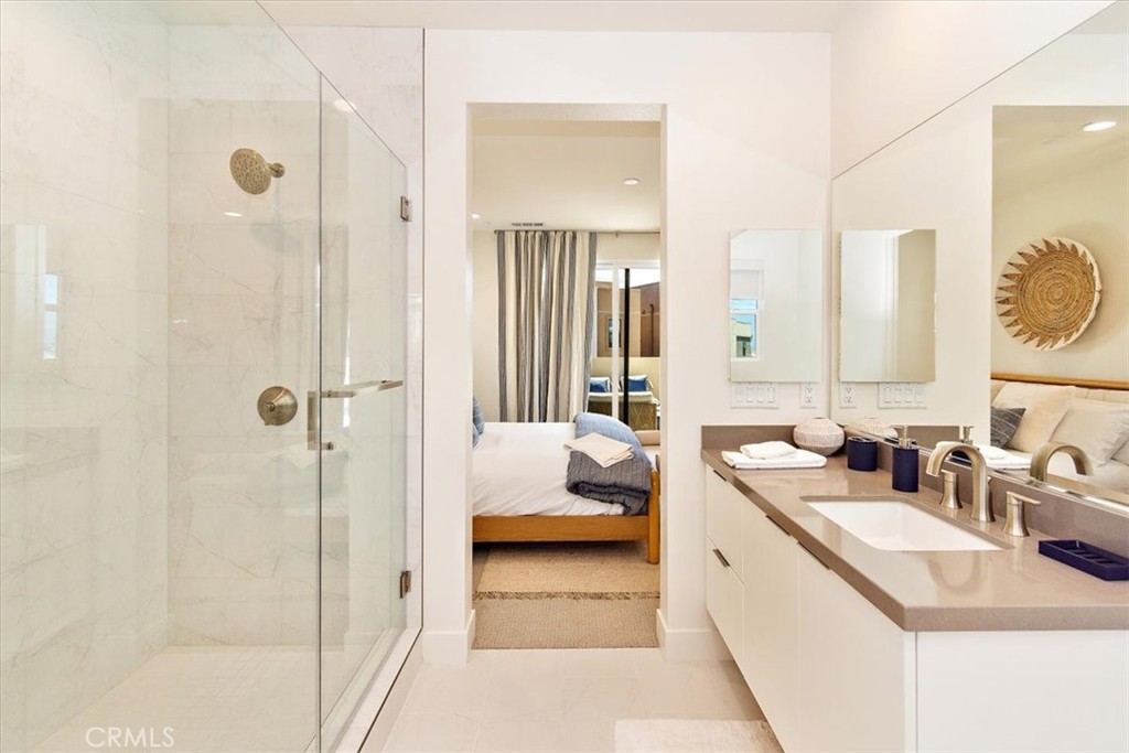 1030 Harbor Boulevard Oxnard, CA 93035 - Photo 27 of 40 a en suite bathroom with a double vanity sink and mirror