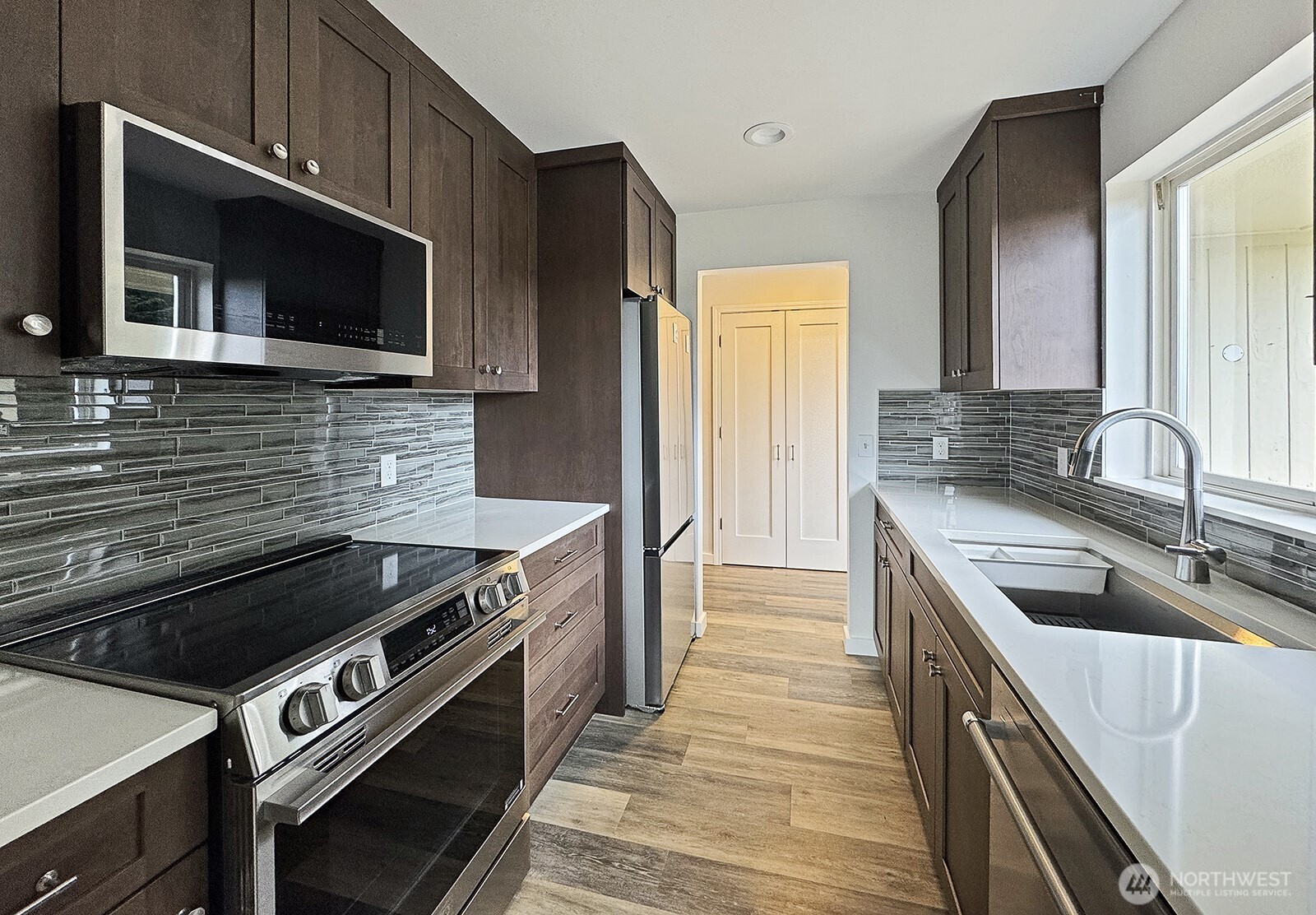 3760 Periwinkle Road Clinton, WA 98236 - Photo 10 of 34 a kitchen with a stove and a microwave