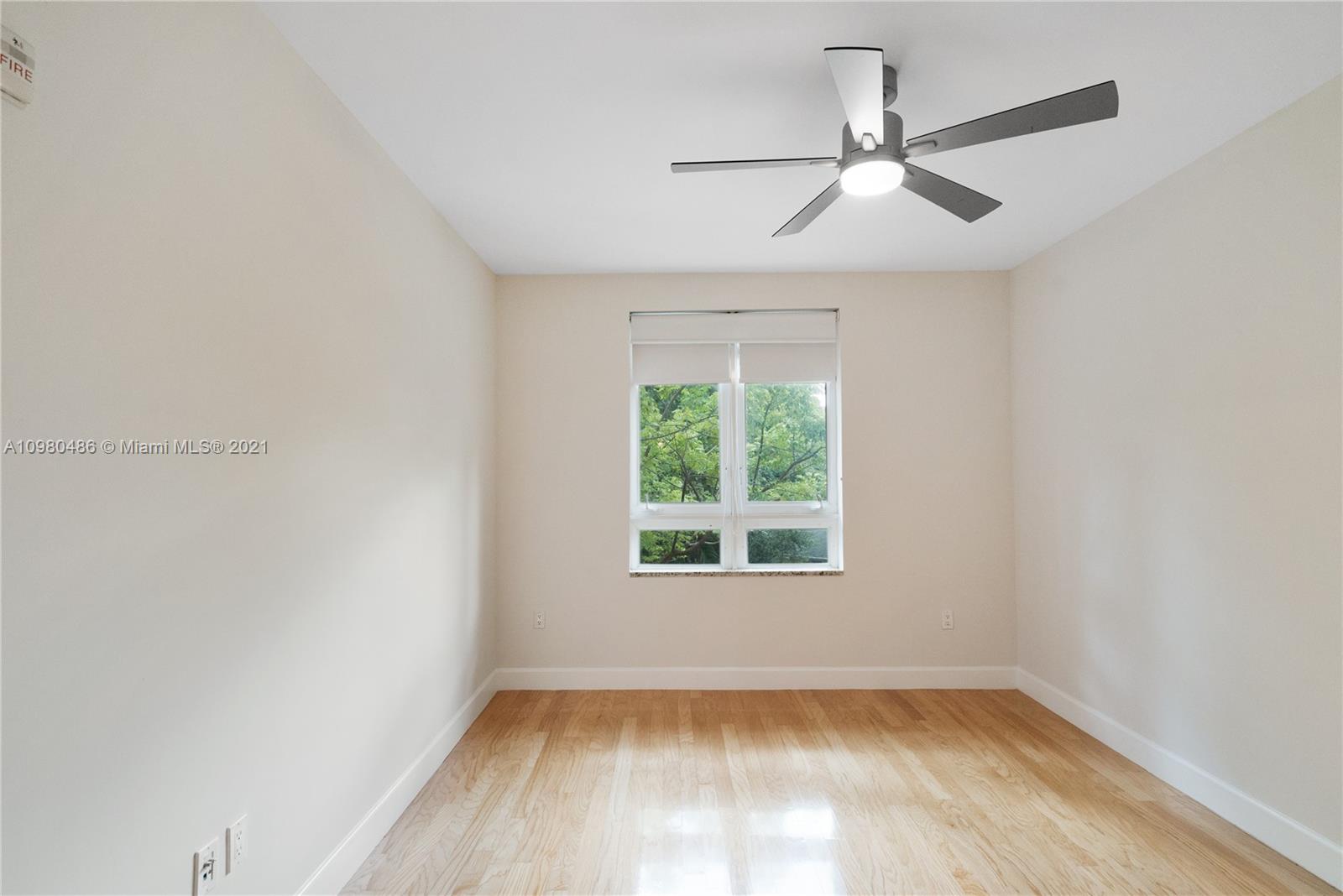 3540 Main Highway, Unit 309 Miami, FL 33133 - Photo 14 of 34 an empty room with a window and a fan