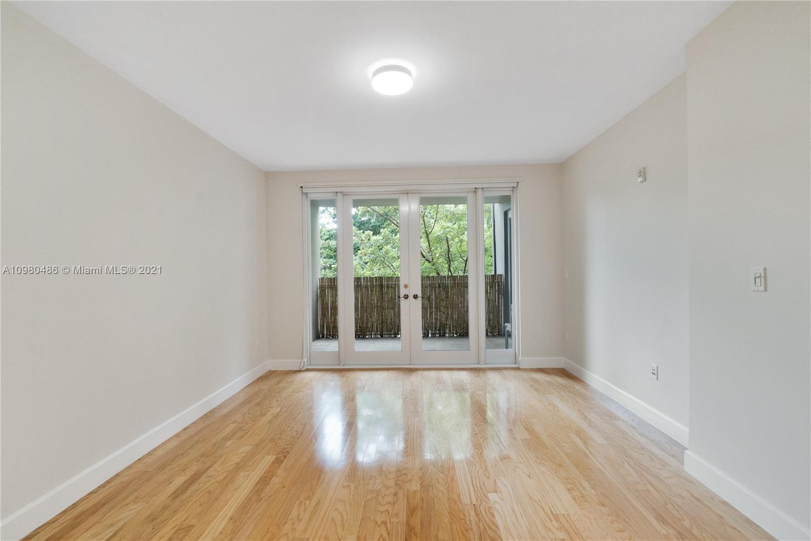 3540 Main Highway, Unit 309 Miami, FL 33133 - Photo 18 of 34 wooden floor in an empty room with a window