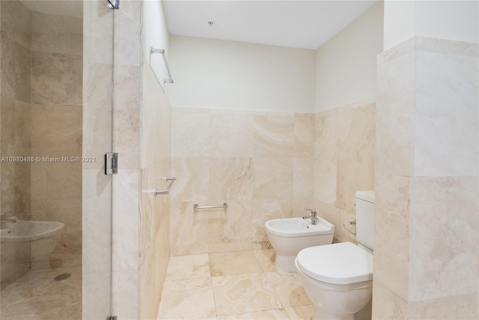 3540 Main Highway, Unit 309 Miami, FL 33133 - Photo 26 of 34 a bathroom with a toilet and a shower