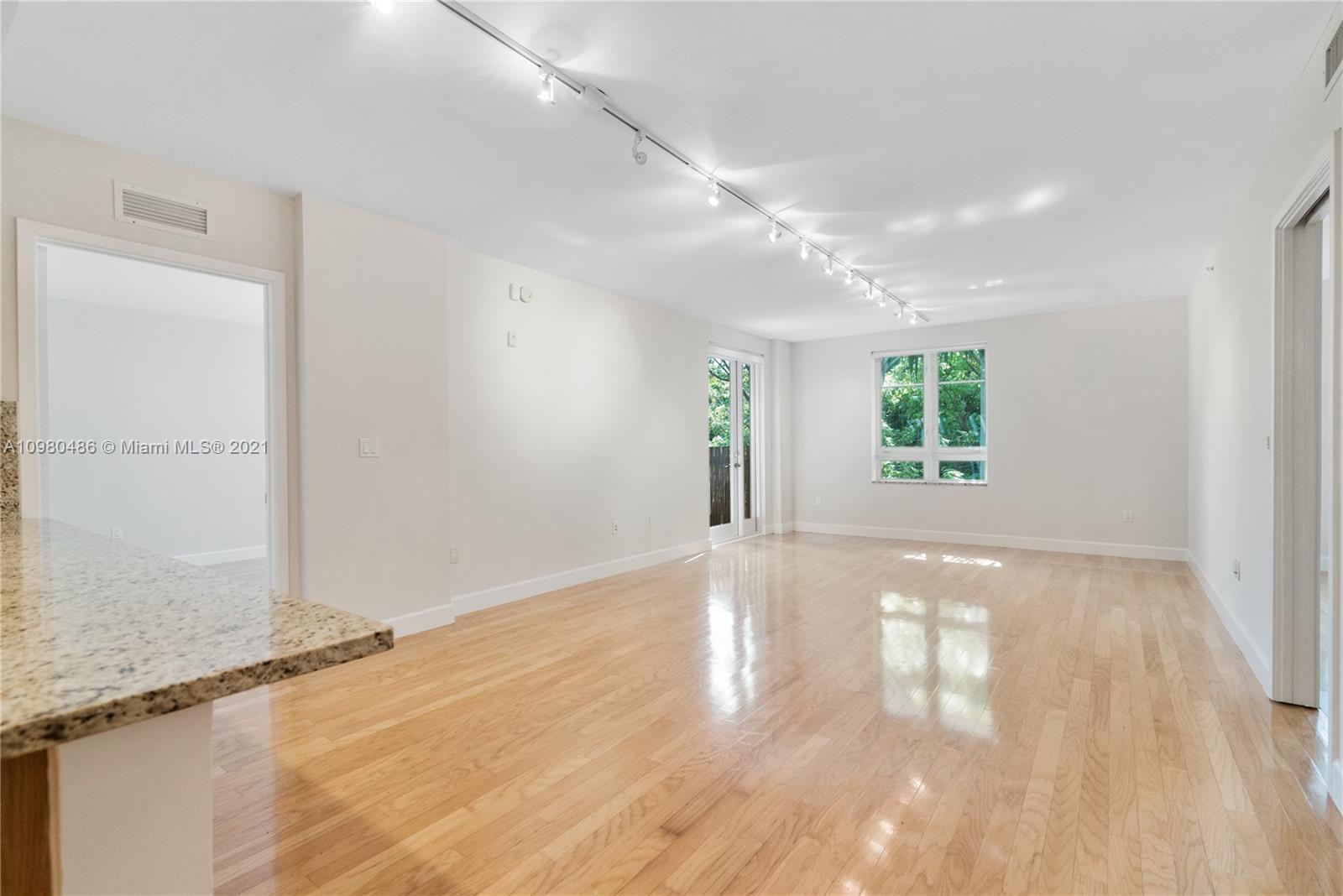 3540 Main Highway, Unit 309 Miami, FL 33133 - Photo 3 of 34 wooden floor in an empty room with a window