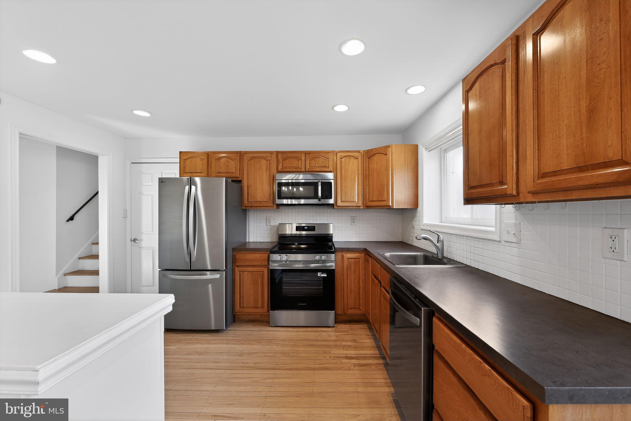 1567 Sugartown Road Paoli, PA 19301 - Photo 12 of 32 a kitchen with stainless steel appliances granite countertop a refrigerator a sink and a stove