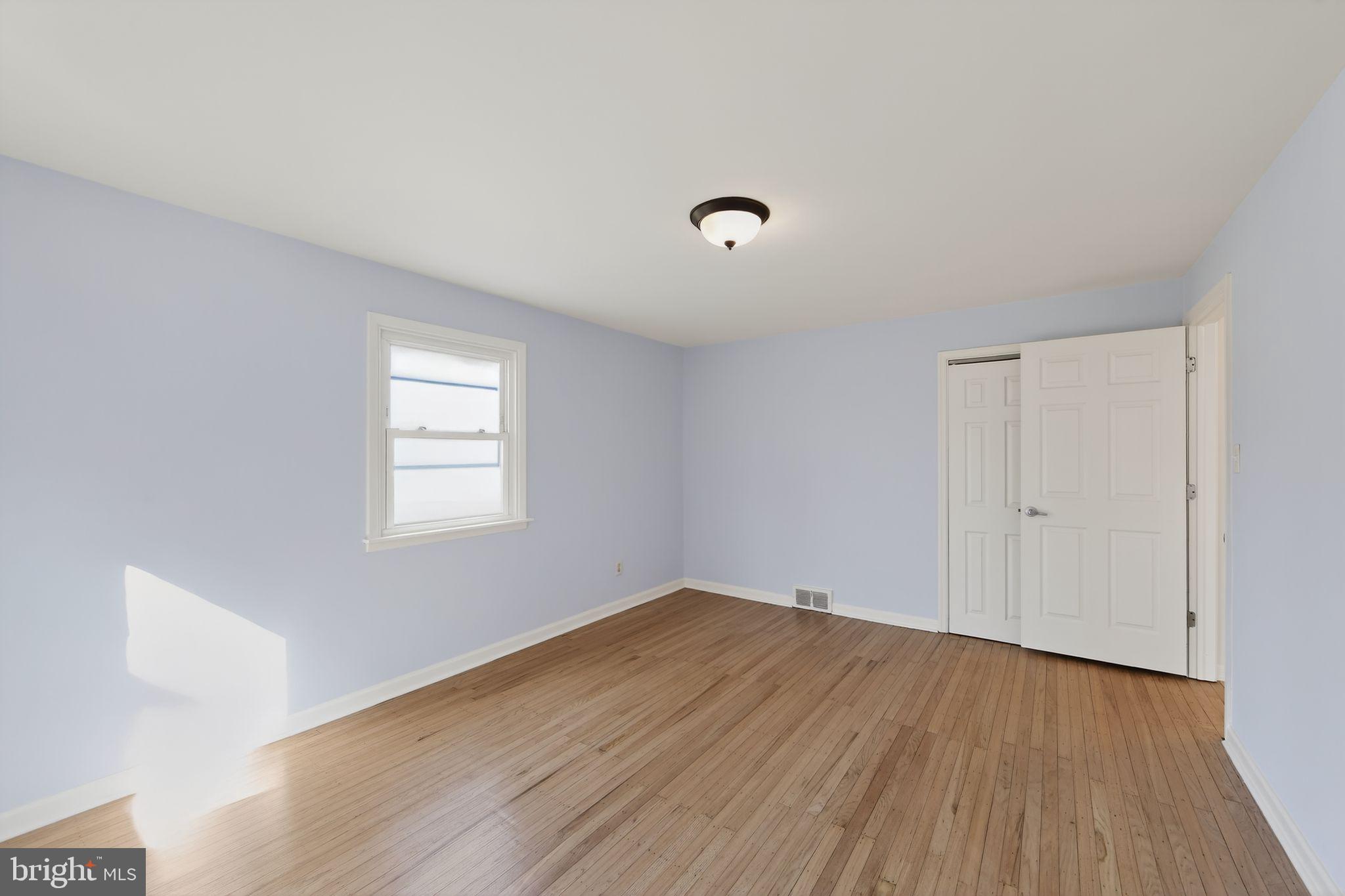 1567 Sugartown Road Paoli, PA 19301 - Photo 16 of 32 a view of a room with wooden floor and windows