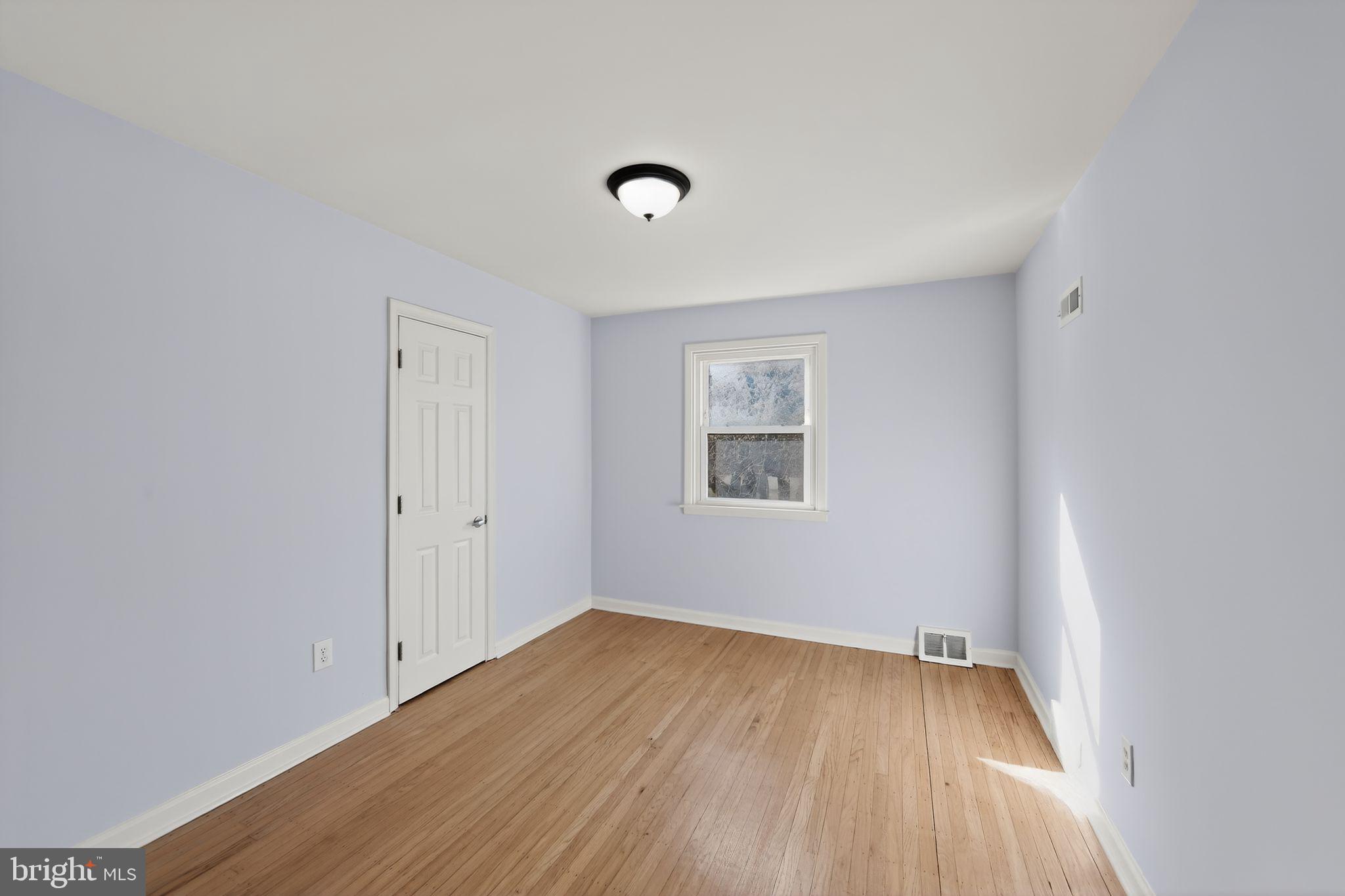 1567 Sugartown Road Paoli, PA 19301 - Photo 20 of 32 wooden floor in an empty room with a window