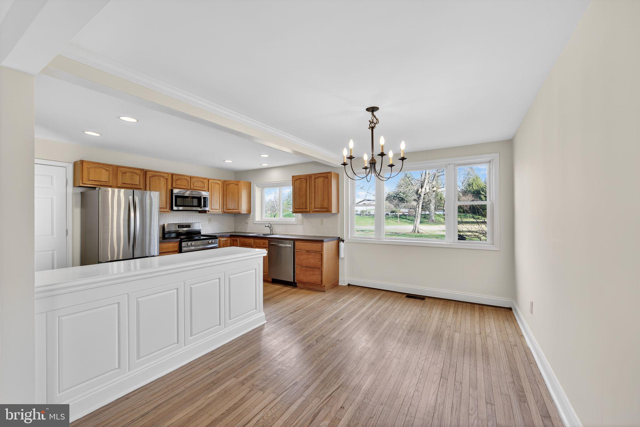 1567 Sugartown Road Paoli, PA 19301 - Photo 9 of 32 a large kitchen with stainless steel appliances a large counter top a sink and a dishwasher