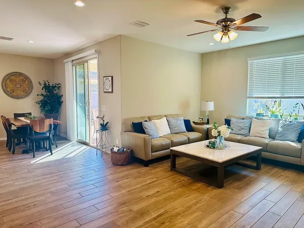 a kitchen with a dining table chairs and cabinets