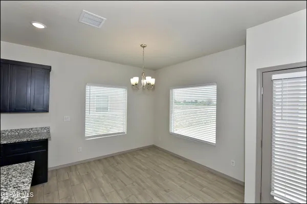 a view of an empty room with a window and fireplace