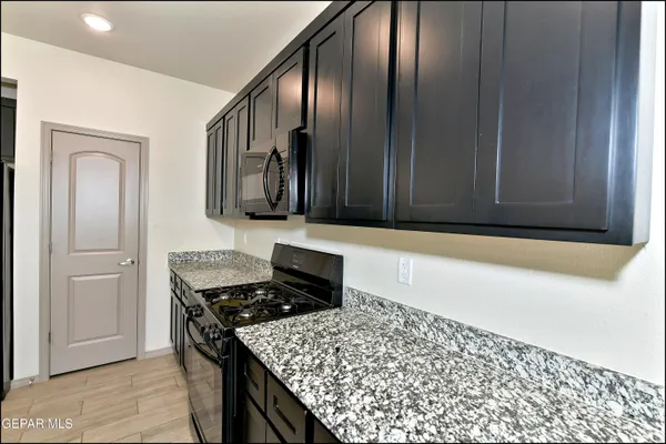 a kitchen with a stove and a microwave