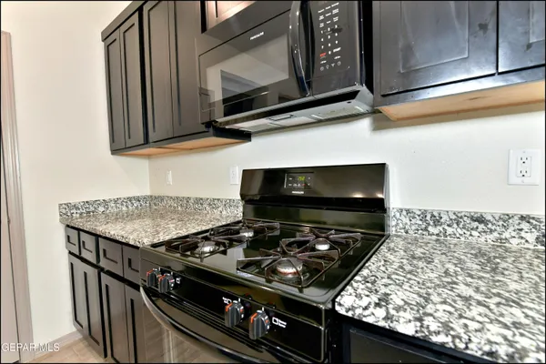 a stove top oven sitting inside of a kitchen
