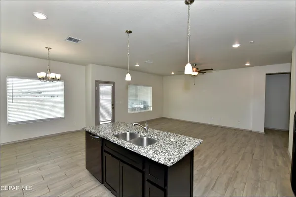 a bathroom with a granite countertop sink a toilet and mirror