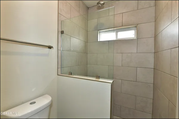 a bathroom with a toilet and a shower
