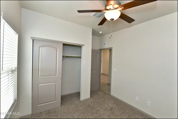 a bathroom with a granite countertop bathtub shower sink vanity and toilet
