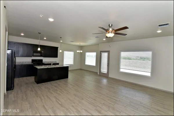 a large kitchen with a large counter top appliances and cabinets