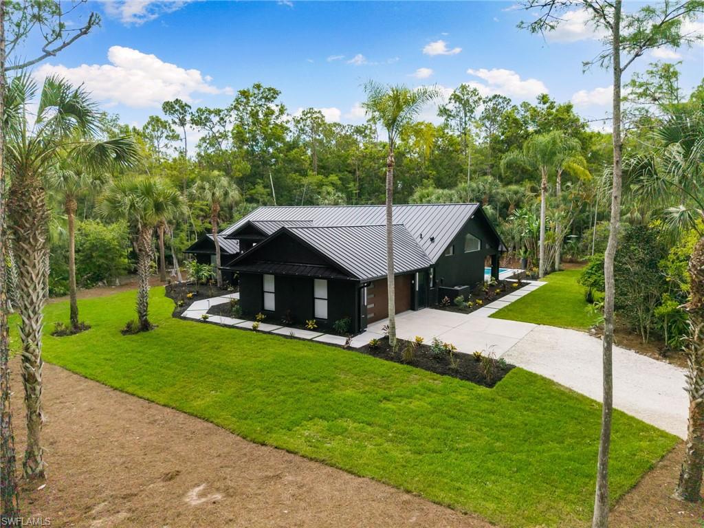 4521 3rd Avenue Northwest Naples, FL 34119 - Photo 3 of 46 a aerial view of a house with a big yard and potted plants