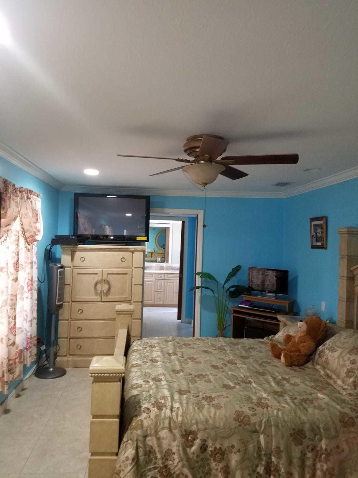 437 Kirk Road Palm Springs, FL 33461 - Photo 13 of 53 a bedroom with a bed and a dresser