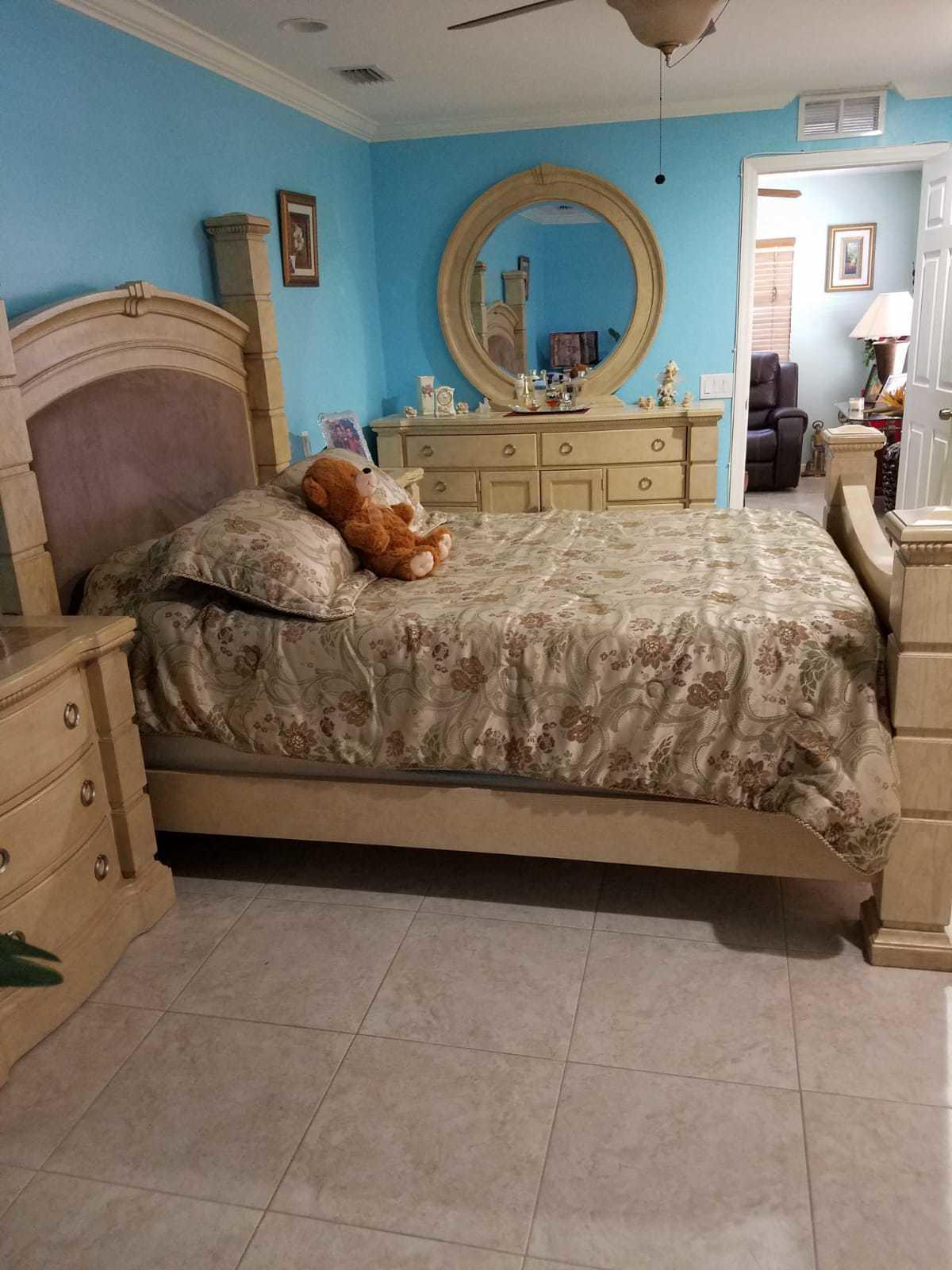 437 Kirk Road Palm Springs, FL 33461 - Photo 14 of 53 a bedroom with a bed a mirror on dresser and a table