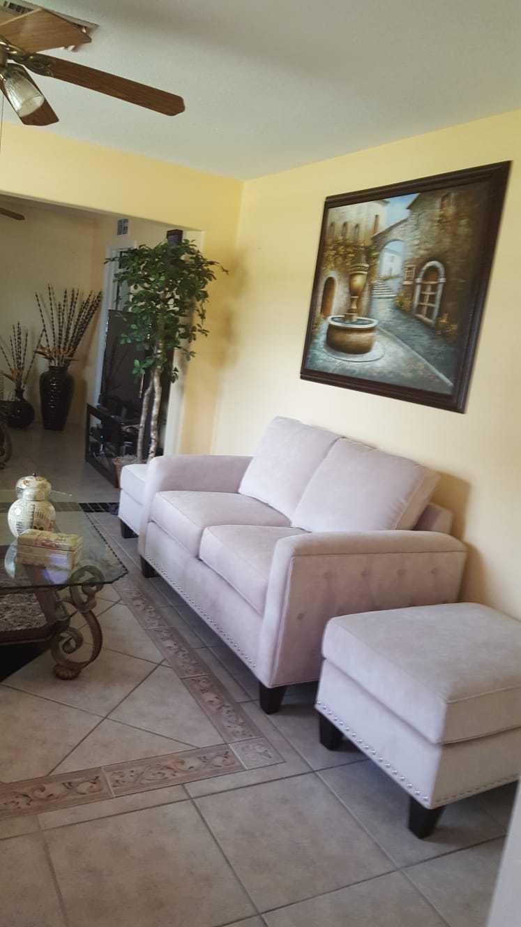 437 Kirk Road Palm Springs, FL 33461 - Photo 2 of 53 a living room with furniture and a flat screen tv
