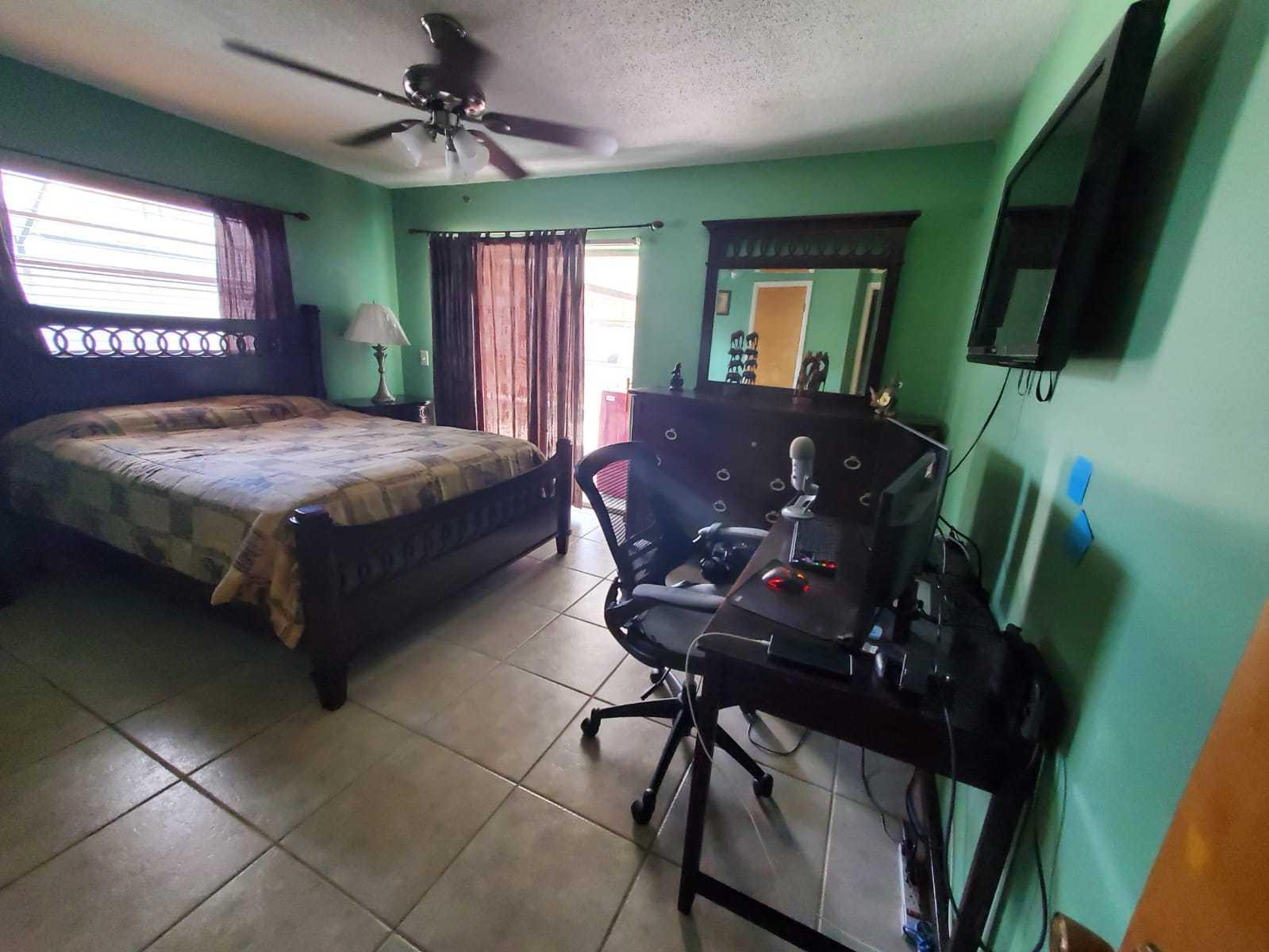 437 Kirk Road Palm Springs, FL 33461 - Photo 23 of 53 a bedroom with a bed dresser and a flat screen tv