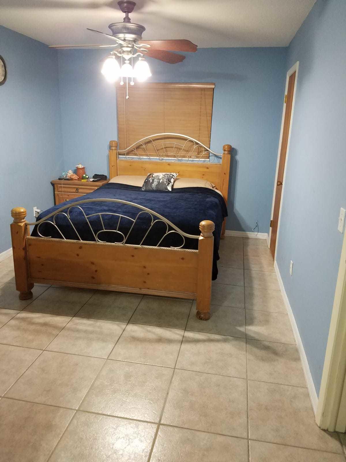 437 Kirk Road Palm Springs, FL 33461 - Photo 29 of 53 a bedroom with a bed and a chandelier