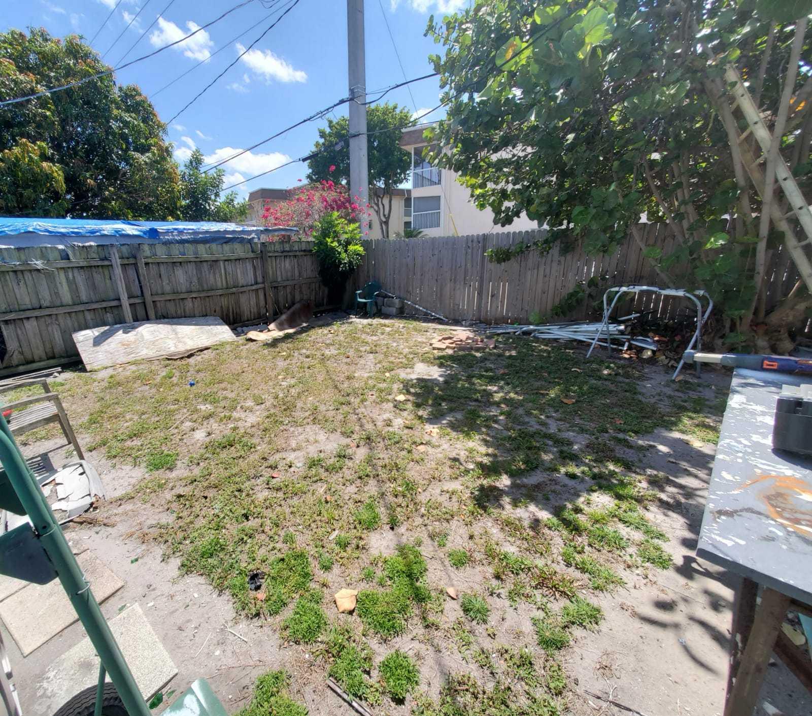 437 Kirk Road Palm Springs, FL 33461 - Photo 43 of 53 a view of a backyard with a barbeque and a large tree