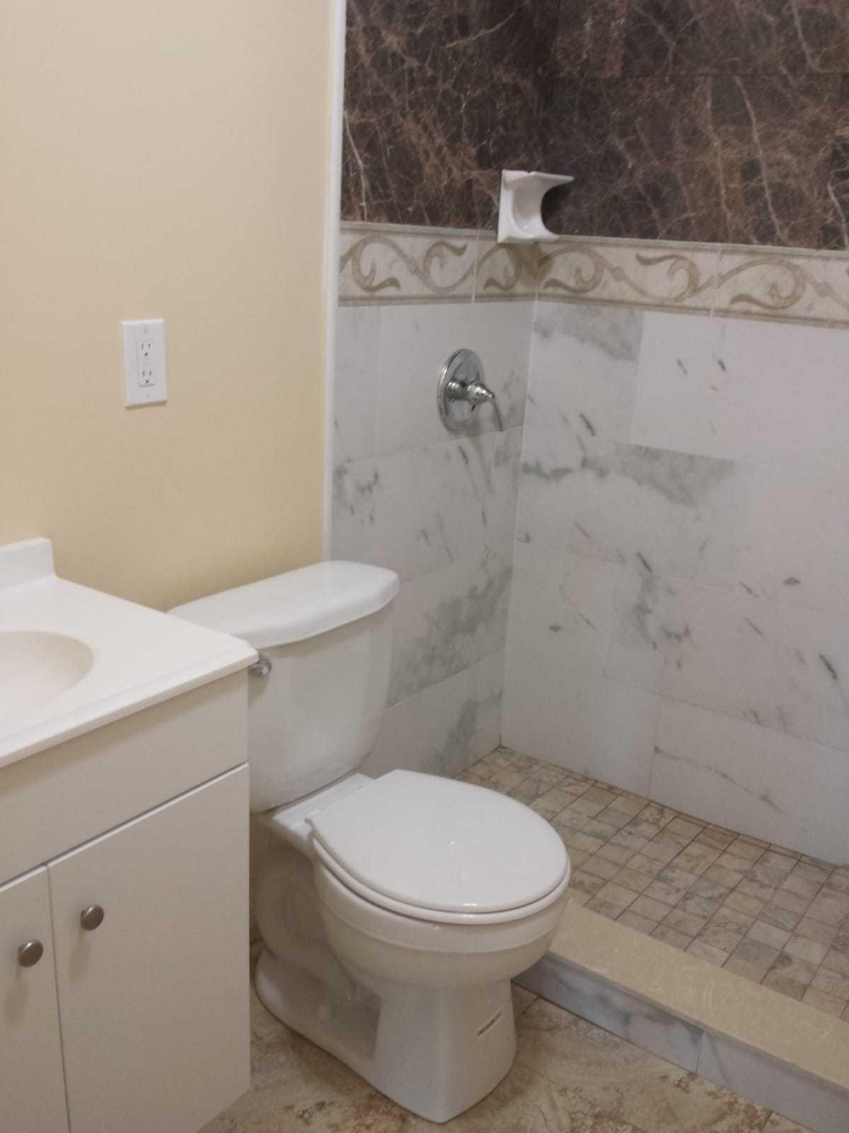 437 Kirk Road Palm Springs, FL 33461 - Photo 46 of 53 a white toilet sitting next to a bathroom sink