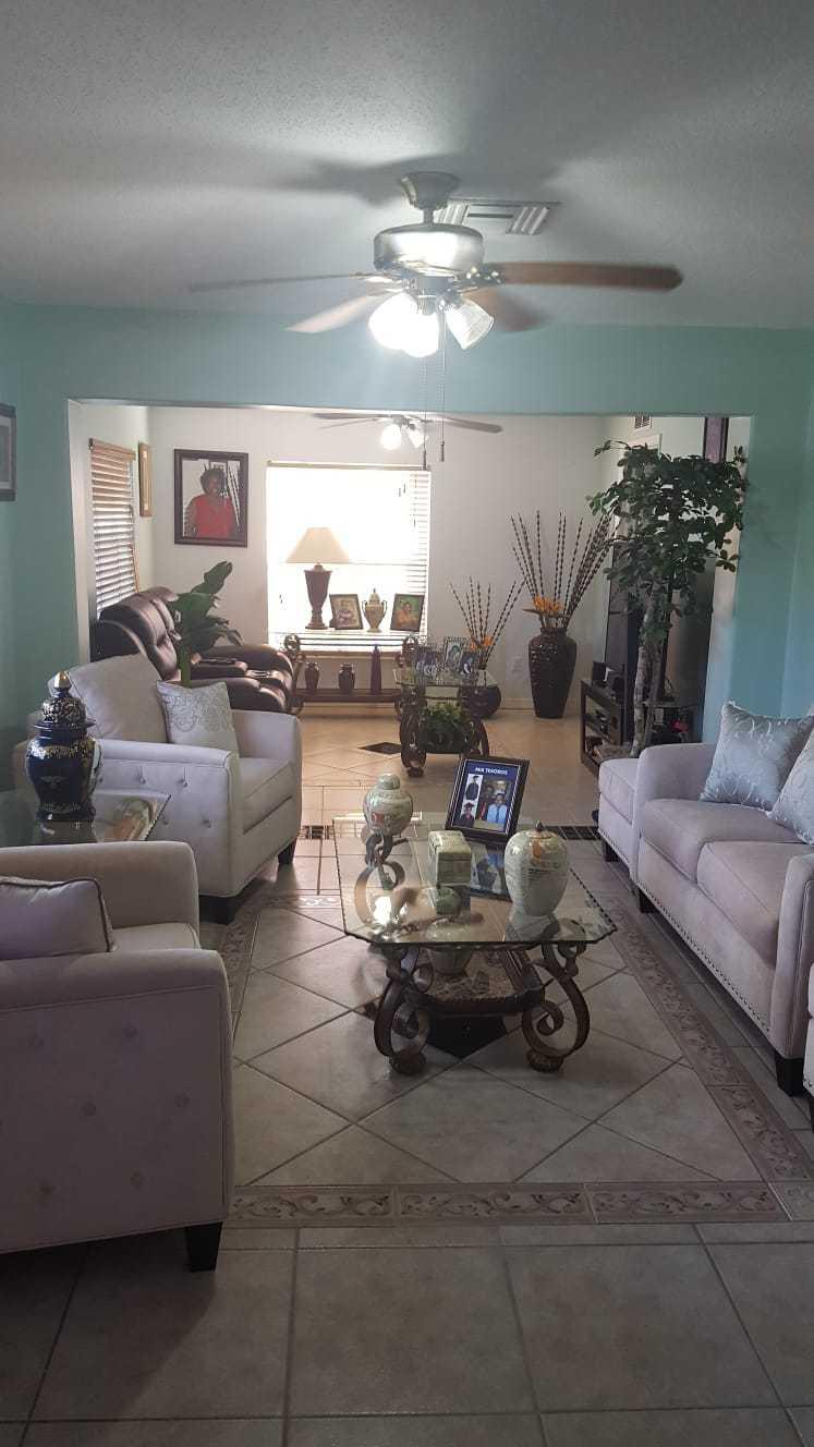 437 Kirk Road Palm Springs, FL 33461 - Photo 5 of 53 a living room with furniture and a chandelier