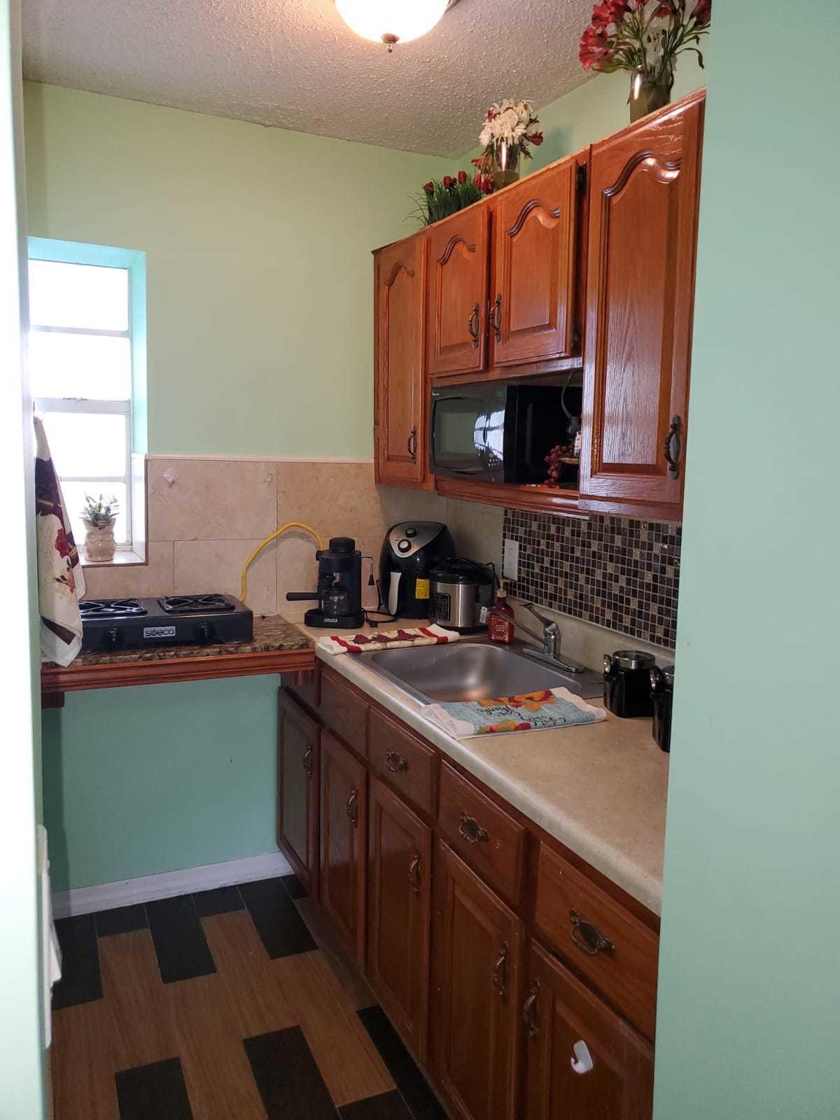 437 Kirk Road Palm Springs, FL 33461 - Photo 51 of 53 a kitchen with a sink stove and microwave