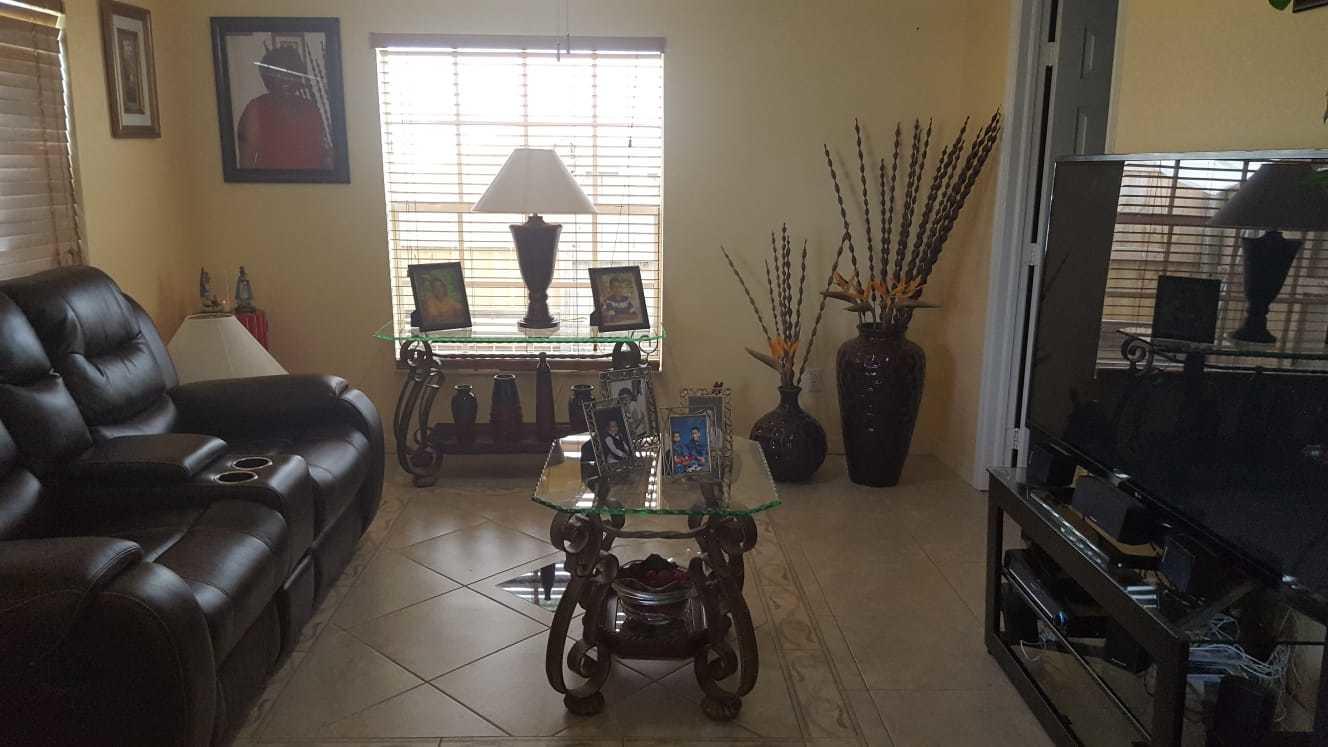 437 Kirk Road Palm Springs, FL 33461 - Photo 6 of 53 a living room with furniture a flat screen tv and a window