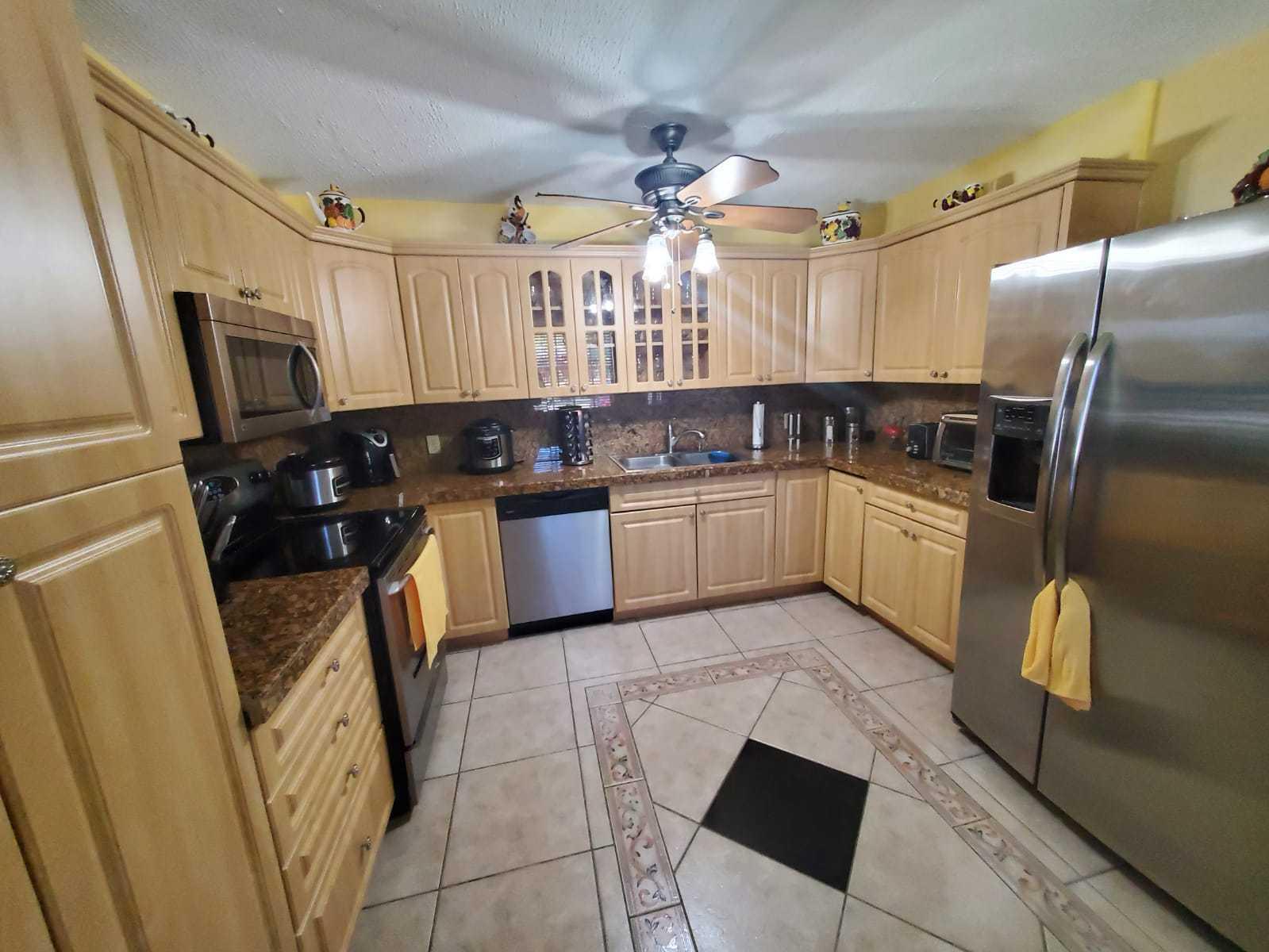 437 Kirk Road Palm Springs, FL 33461 - Photo 10 of 53 a kitchen with granite countertop a sink stainless steel appliances a counter space and cabinets