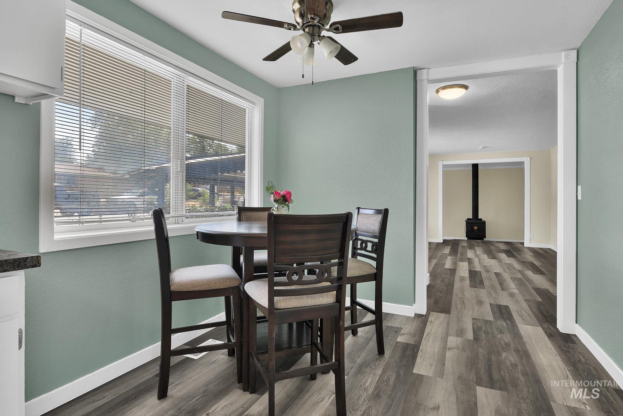 5755 Chuckwagon Road Nampa, ID 83686 - Photo 14 of 50 Wood-finish flooring throughout, with a ceiling fan and a built-in wood-burning stove