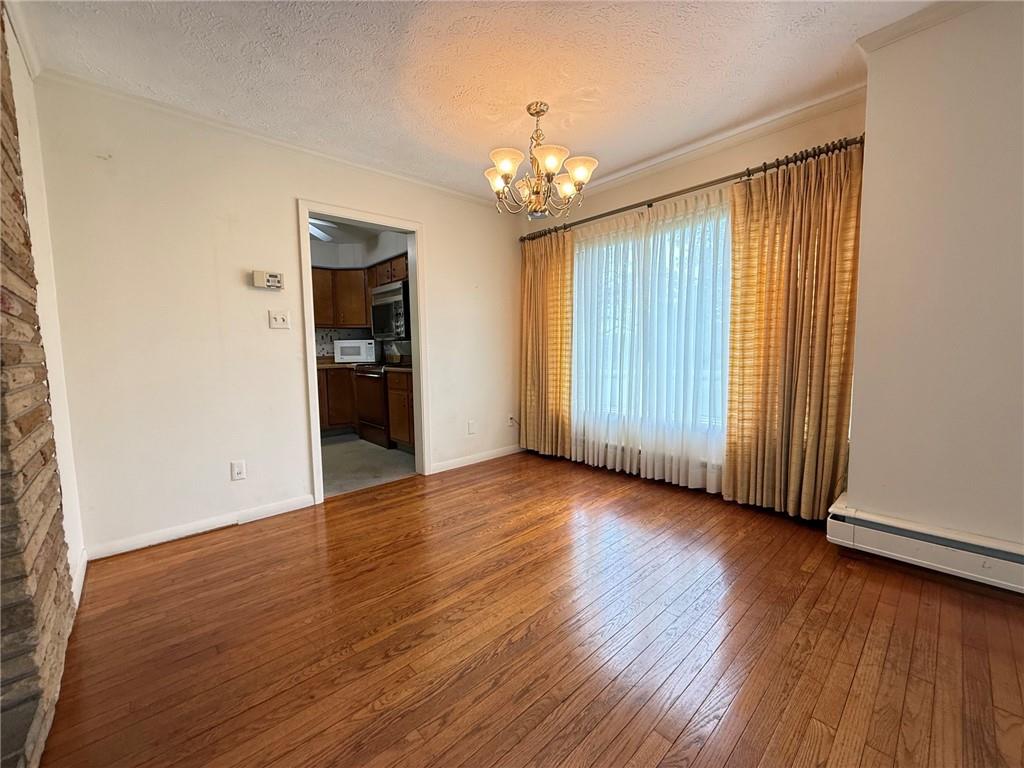 123 Hadley Road Greenville, PA 16125 - Photo 25 of 49 an empty room with wooden floor chandelier and windows