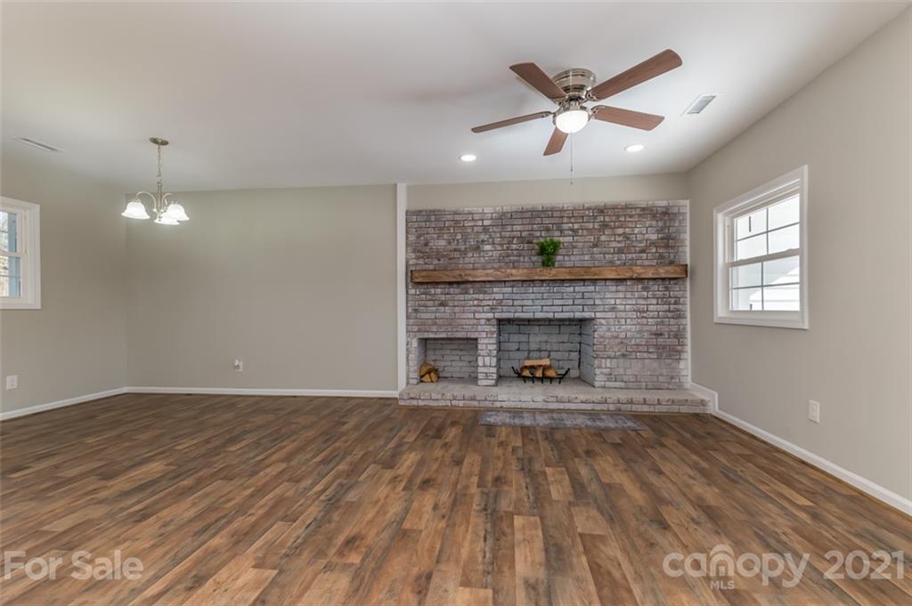 310 Webb Church Road Ellenboro, NC 28040 - Photo 17 of 35 a view of an empty room with wooden floor and a fireplace