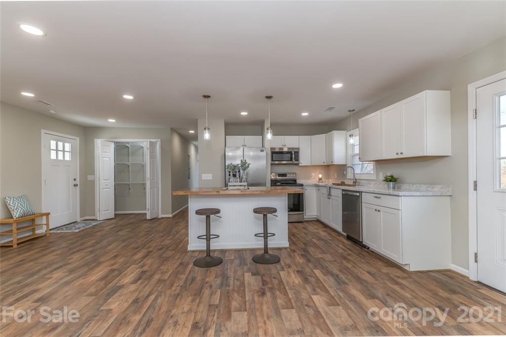 310 Webb Church Road Ellenboro, NC 28040 - Photo 19 of 35 a kitchen with a sink stainless steel appliances and cabinets