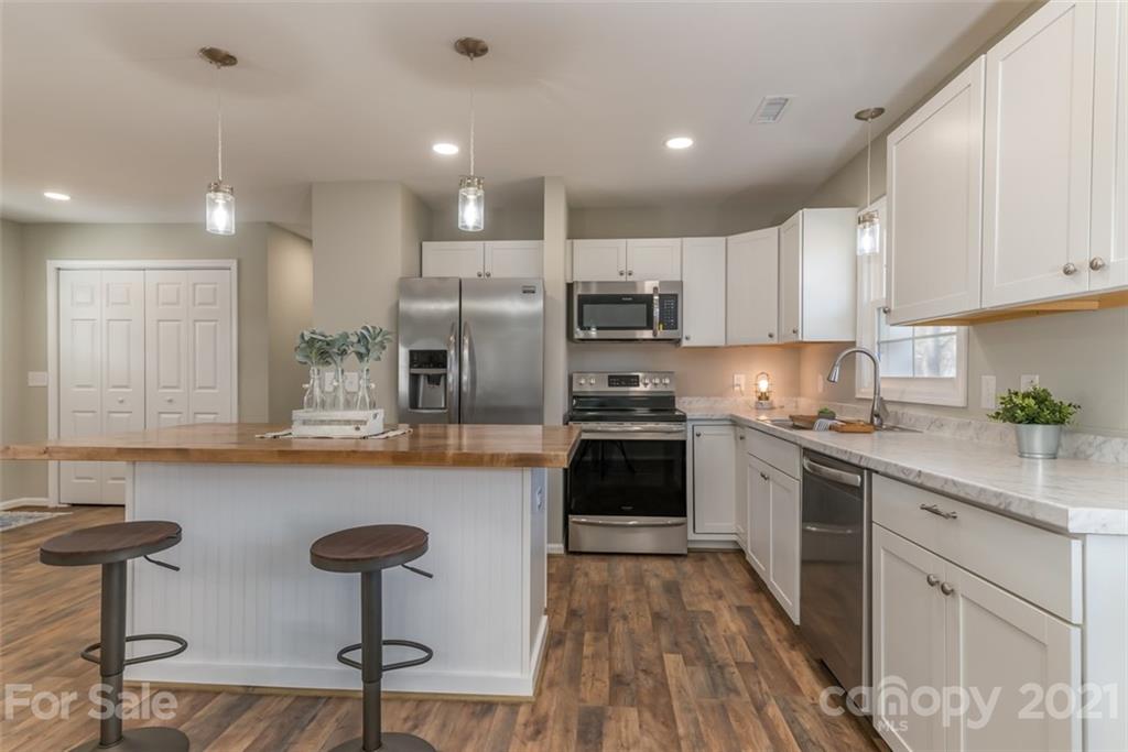 310 Webb Church Road Ellenboro, NC 28040 - Photo 20 of 35 a kitchen with refrigerator and chairs