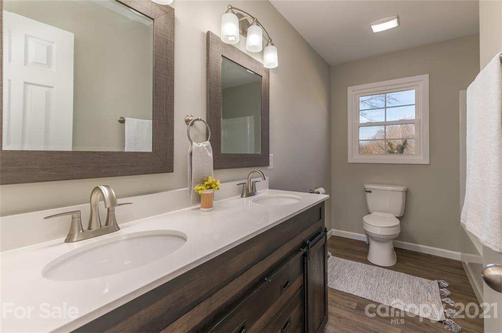310 Webb Church Road Ellenboro, NC 28040 - Photo 25 of 35 a bathroom with a granite countertop sink a toilet and a mirror