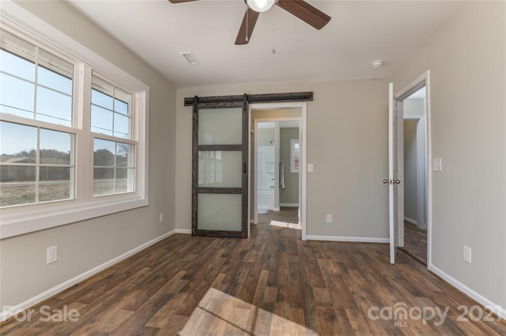 310 Webb Church Road Ellenboro, NC 28040 - Photo 5 of 35 a view of empty room with wooden floor and window