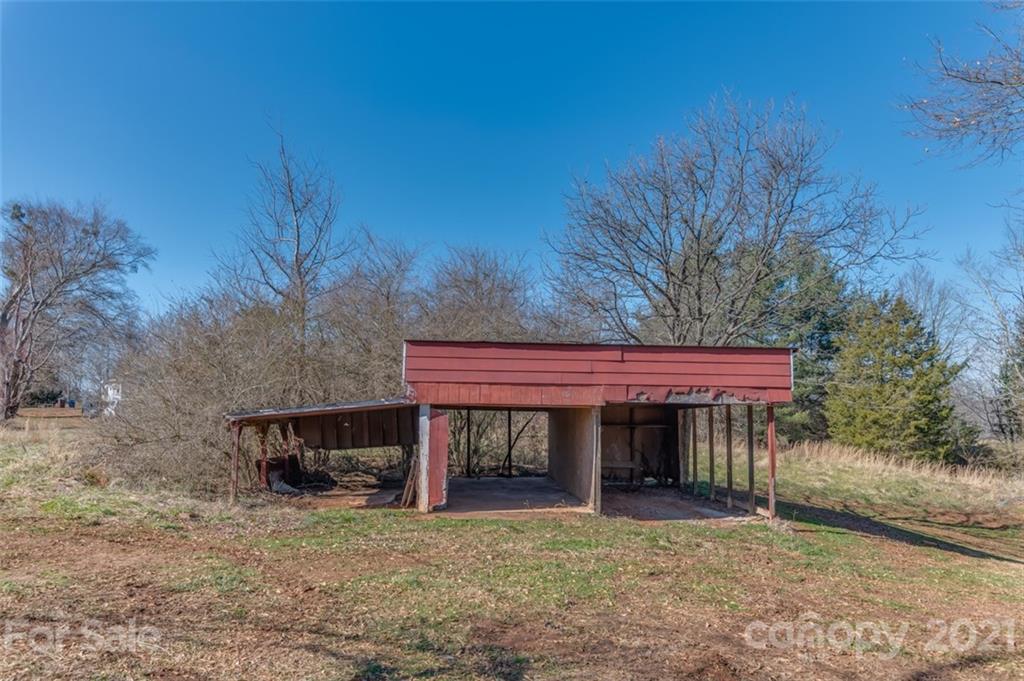 310 Webb Church Road Ellenboro, NC 28040 - Photo 9 of 35 a view of a house with a small yard and a garage