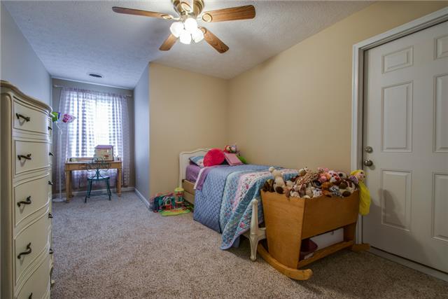 515 Berry Circle Springfield, TN 37172 - Photo 11 of 18 a bedroom with bed and a chandelier
